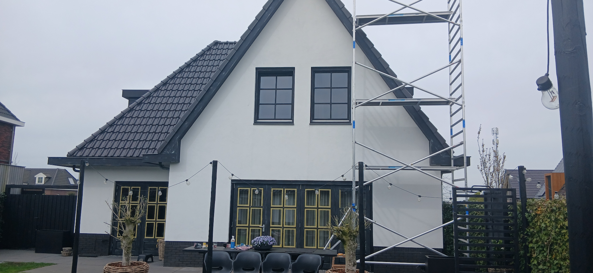 Vers geschilderd wit woonhuis met houten kozijnen en deur